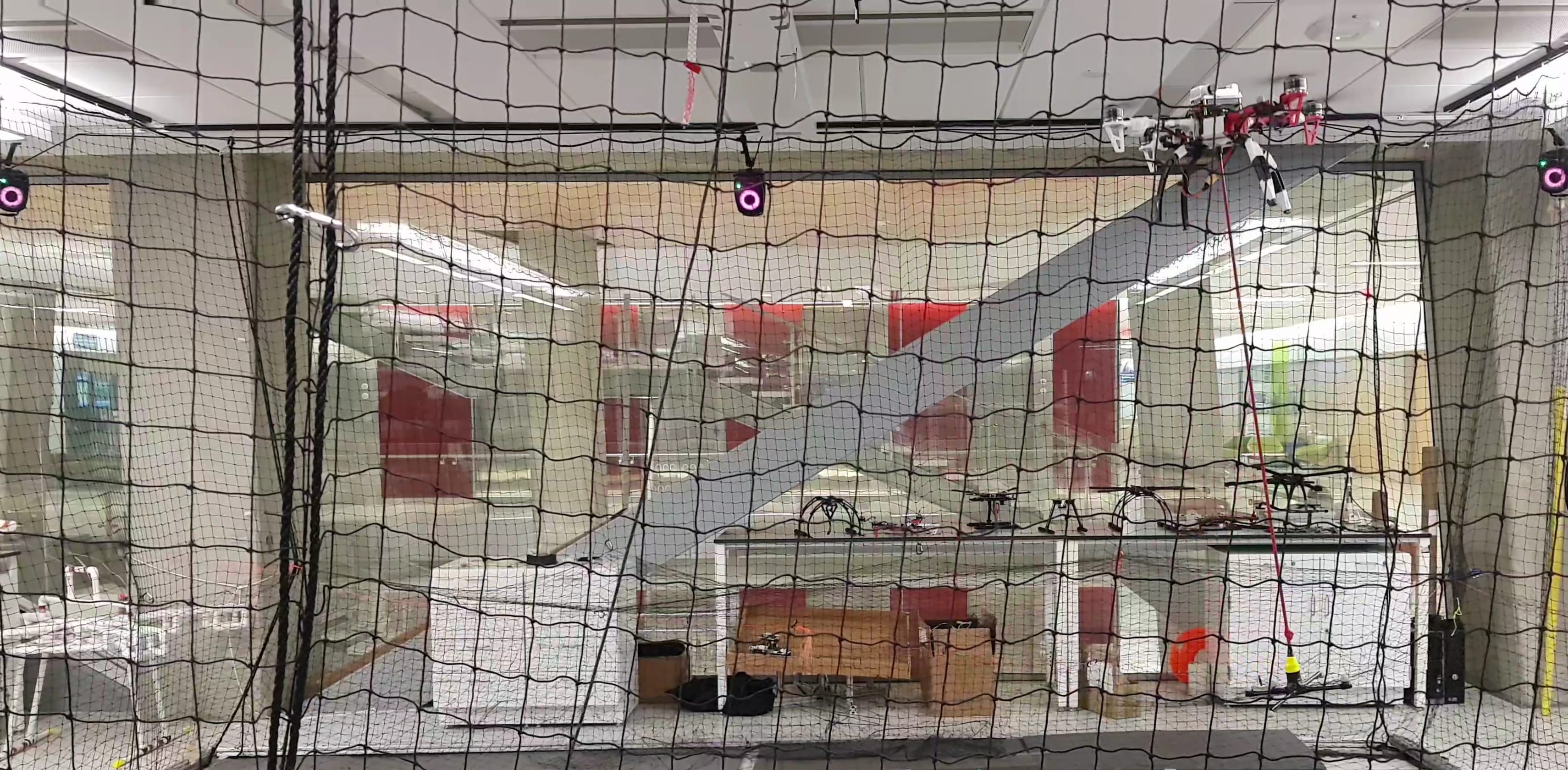 Quadrotor and suspended payload during an indoor flight experiment.